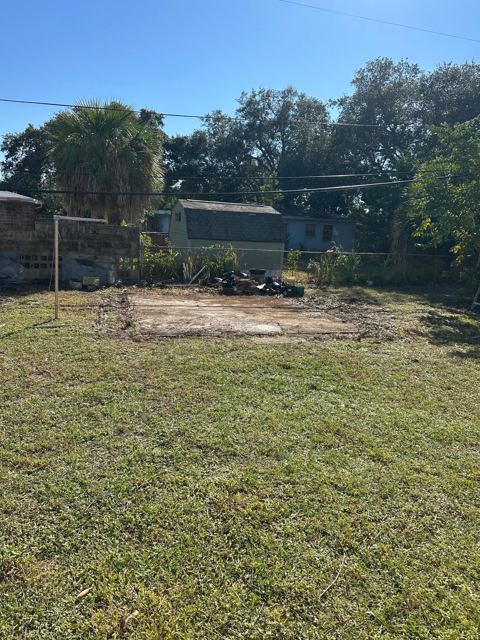 Cleared yard space after shed demolition and debris removal