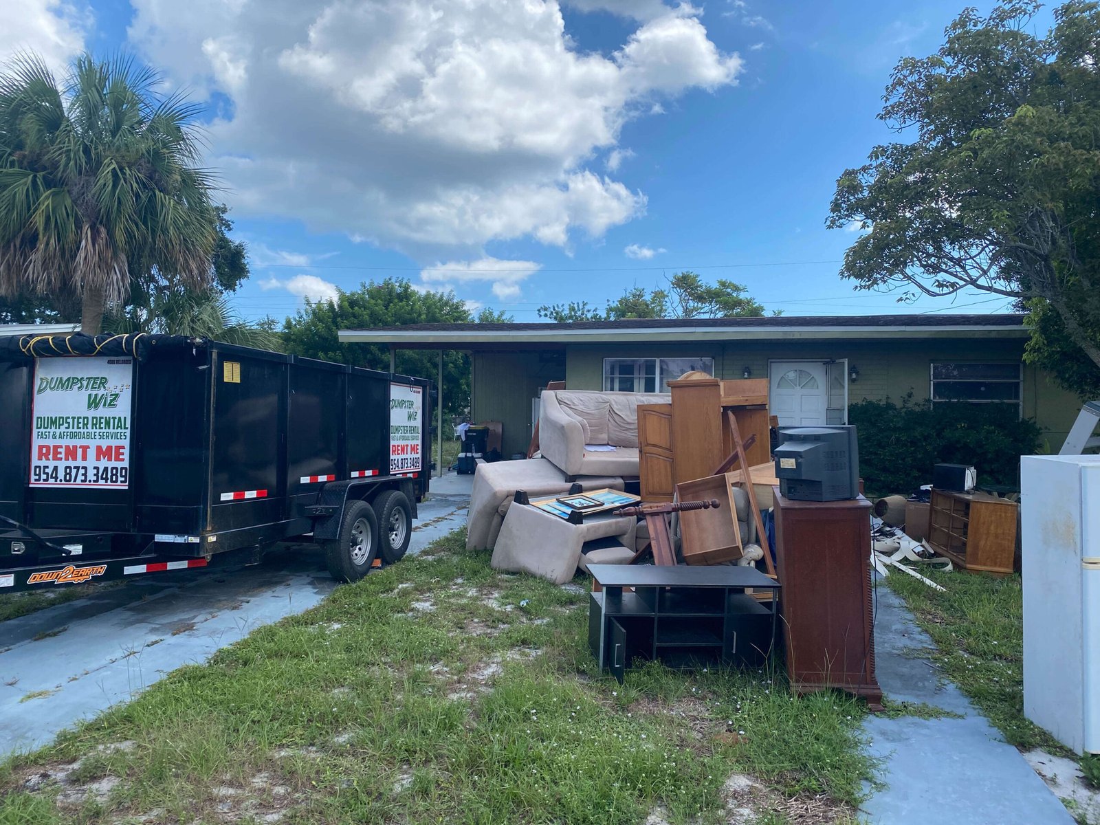 Residential junk removal in Palm Bay, FL with furniture and household debris loaded for haul-away