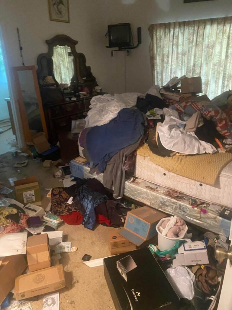 Hoarder living room clutter before junk removal in Rockledge Florida