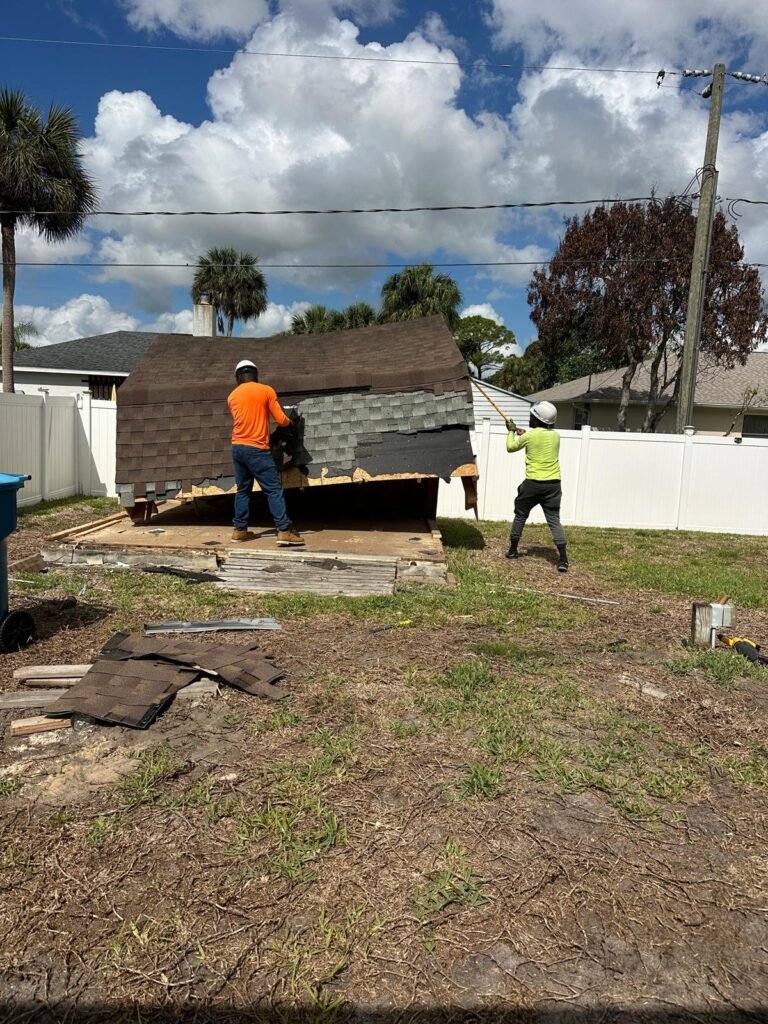 workers dismantling structure during mobile home removal project in Palm Bay Florida