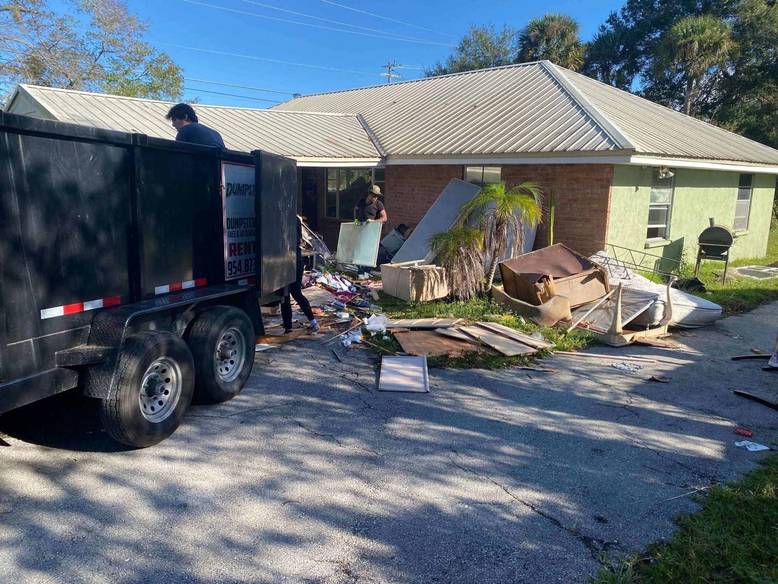 Furniture and household items staged outside a home for property cleanout in Brevard County FL