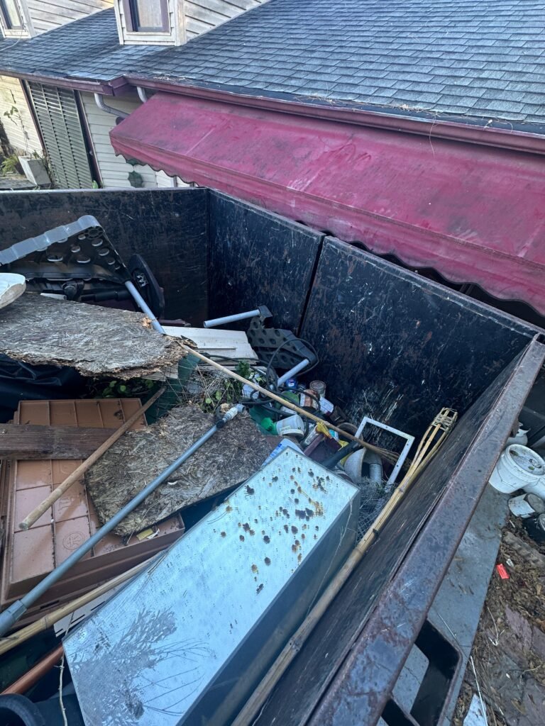 dumpster filled with demolition debris during junk removal in Palm Bay FL