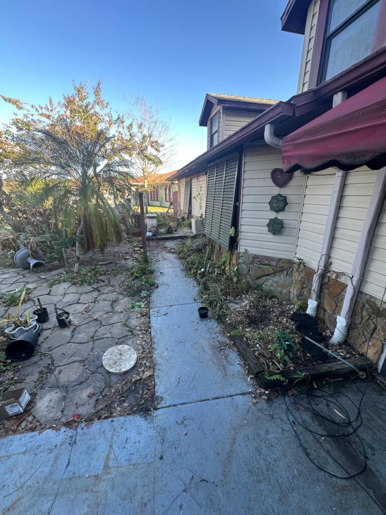 exterior property cleanup and junk removal during a Palm Bay cleanout project