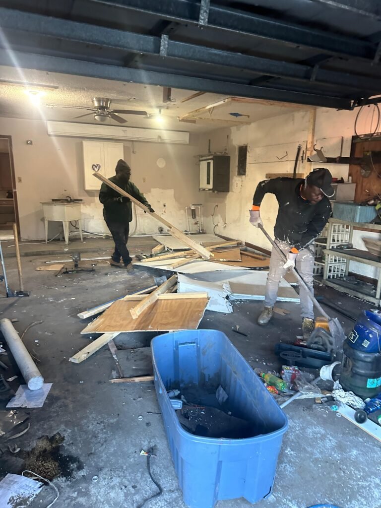 workers clearing demolition debris during a whole house cleanout in Palm Bay