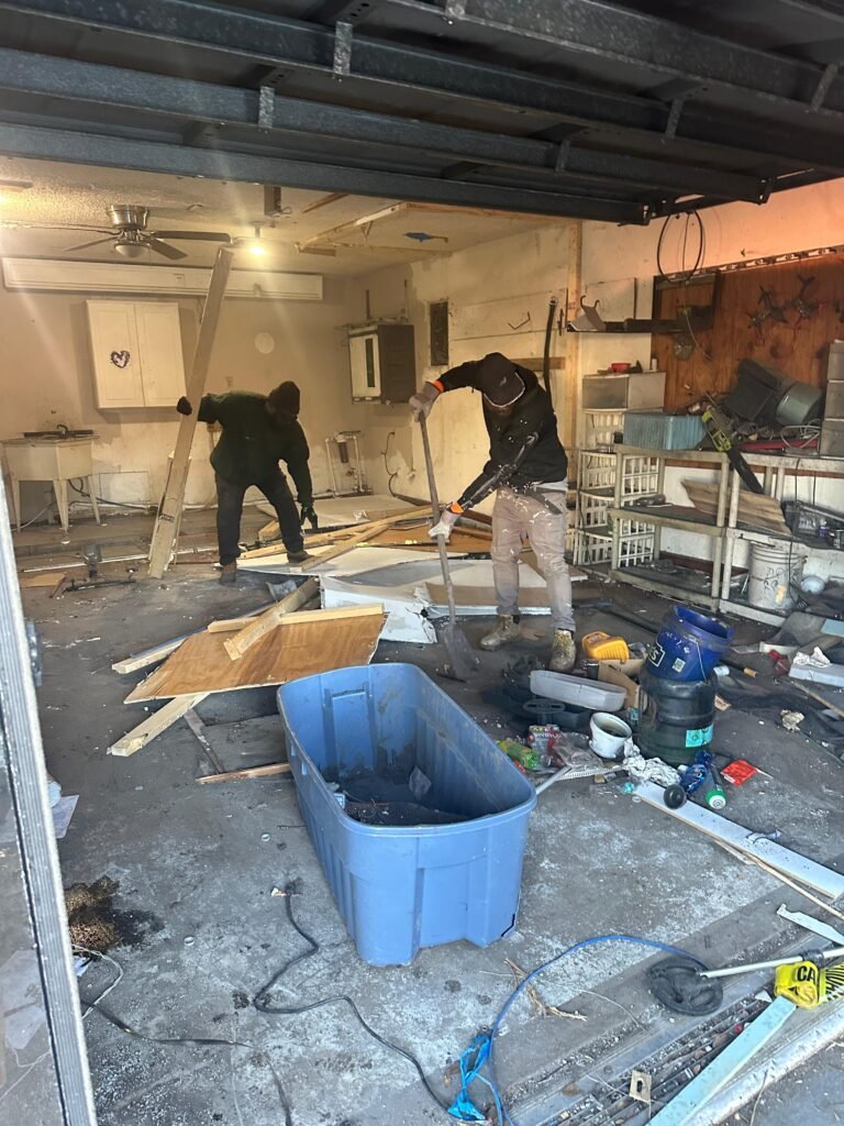 crew removing flooring and debris during house demolition in Brevard County