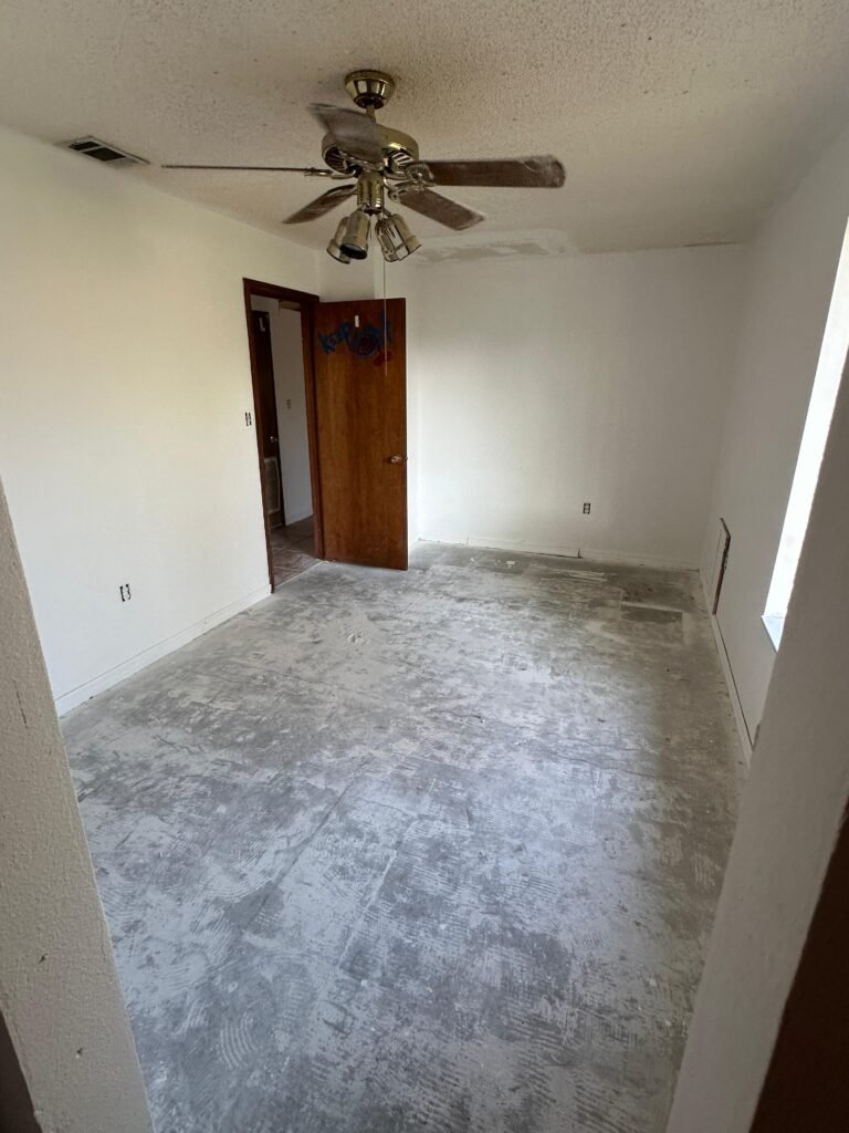 Bedroom with repaired walls and ceiling after Palm Bay junk removal and demolition