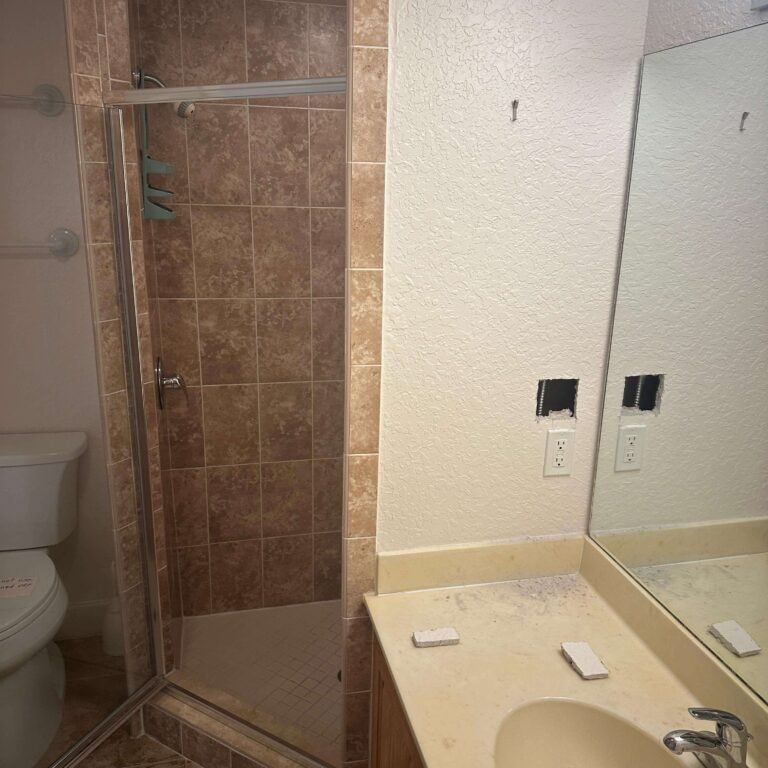 Exposed wall framing and plumbing during interior condo demolition
