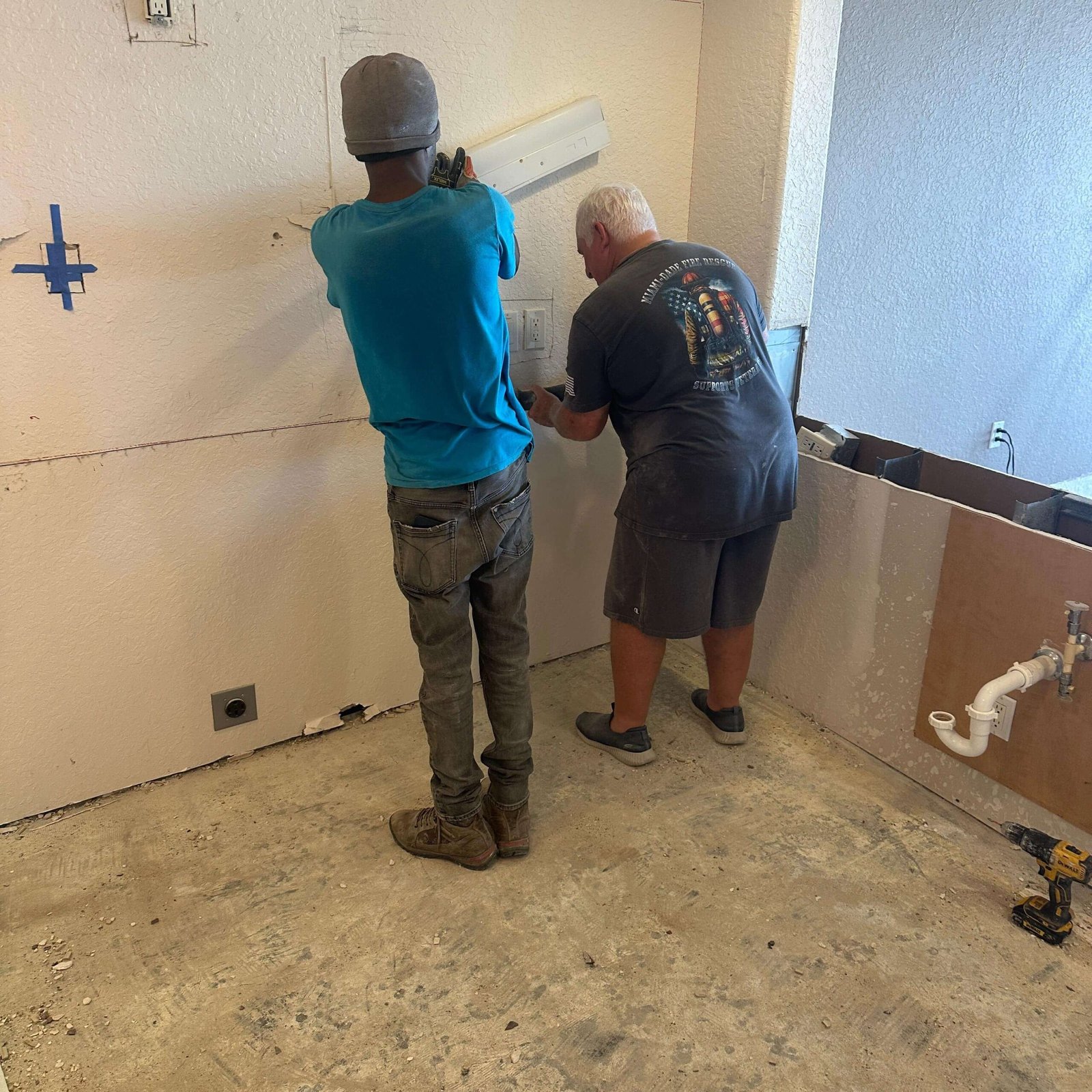 Kitchen with flooring removed during a condo remodeling project