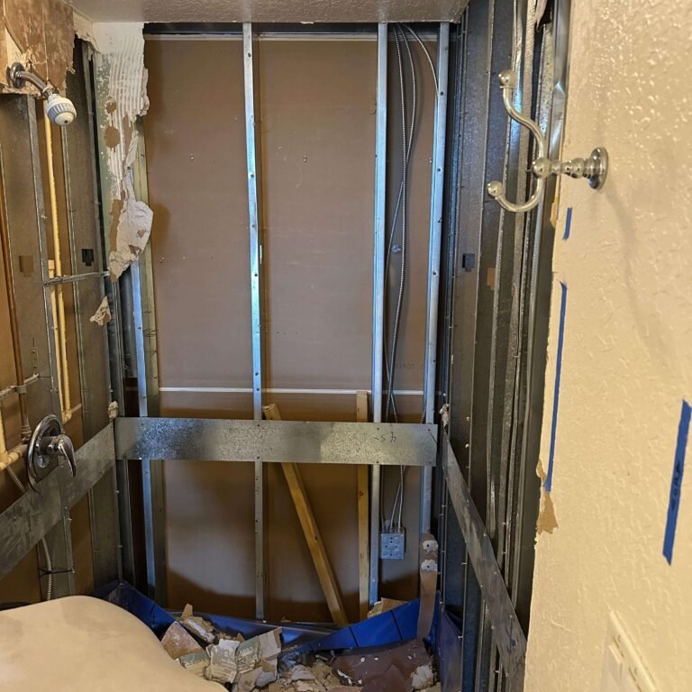Drywall removed to expose wall framing during condo remodeling