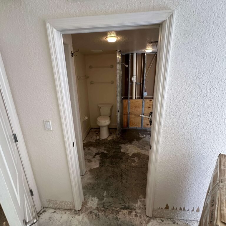 Bathroom partially demolished with wall framing exposed