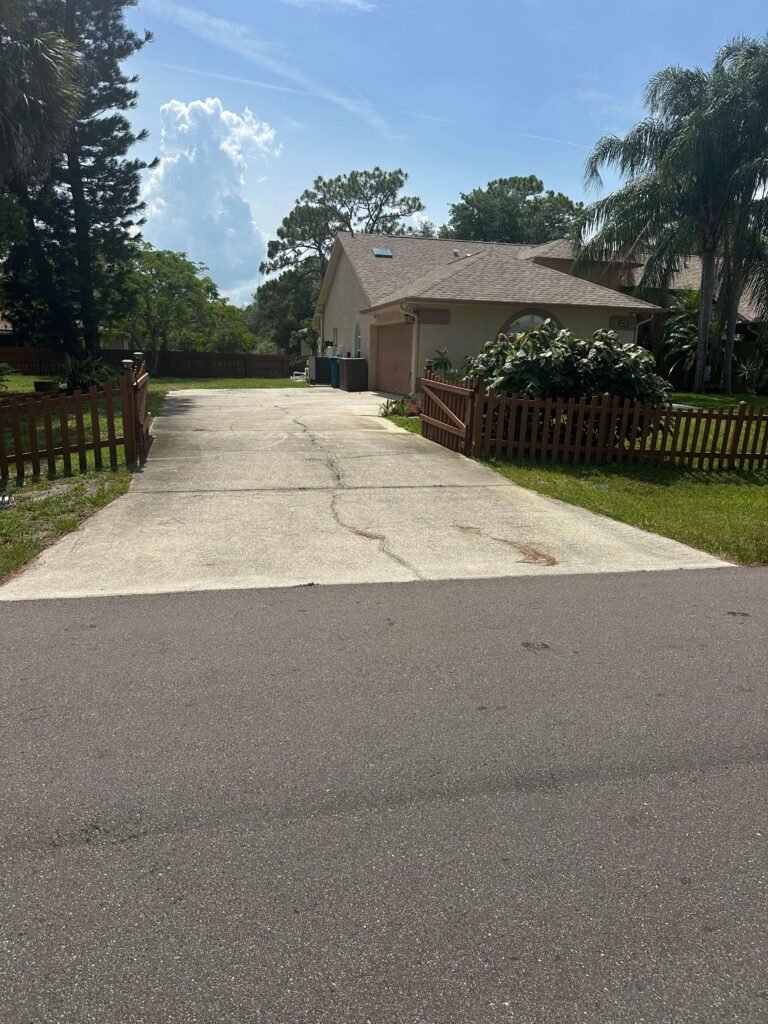 Original cracked concrete driveway at Palm Bay FL home before demolition — Dumpsters Wiz driveway removal
