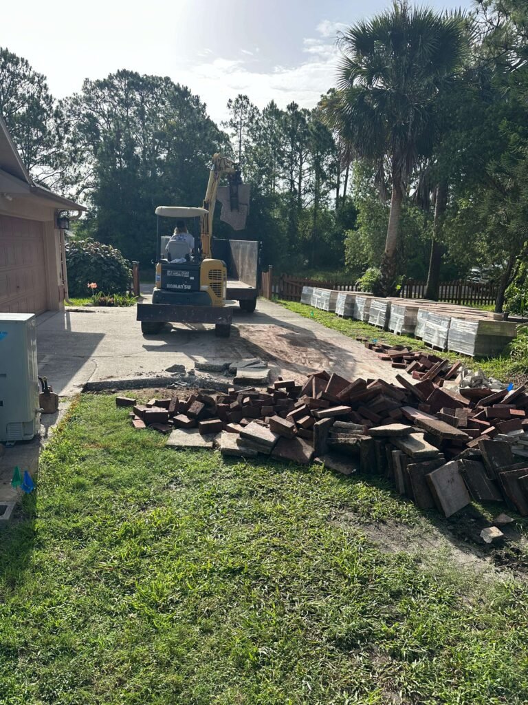 Cracked concrete driveway side view Palm Bay FL — driveway demolition before photo Dumpsters Wiz