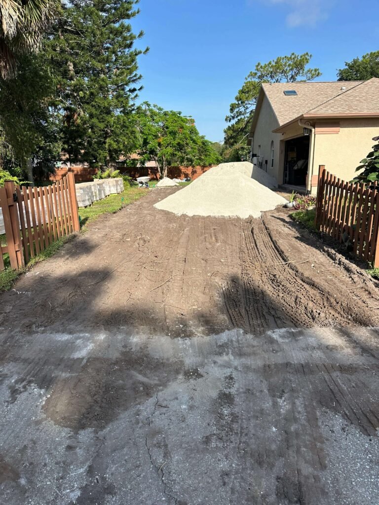 Clear graded driveway base after concrete removal Palm Bay FL — Dumpsters Wiz project completed