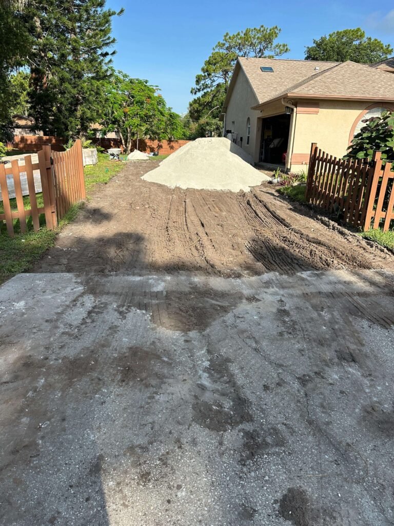 Driveway cleared after concrete demolition and removal Palm Bay FL — bare ground ready for new driveway installation