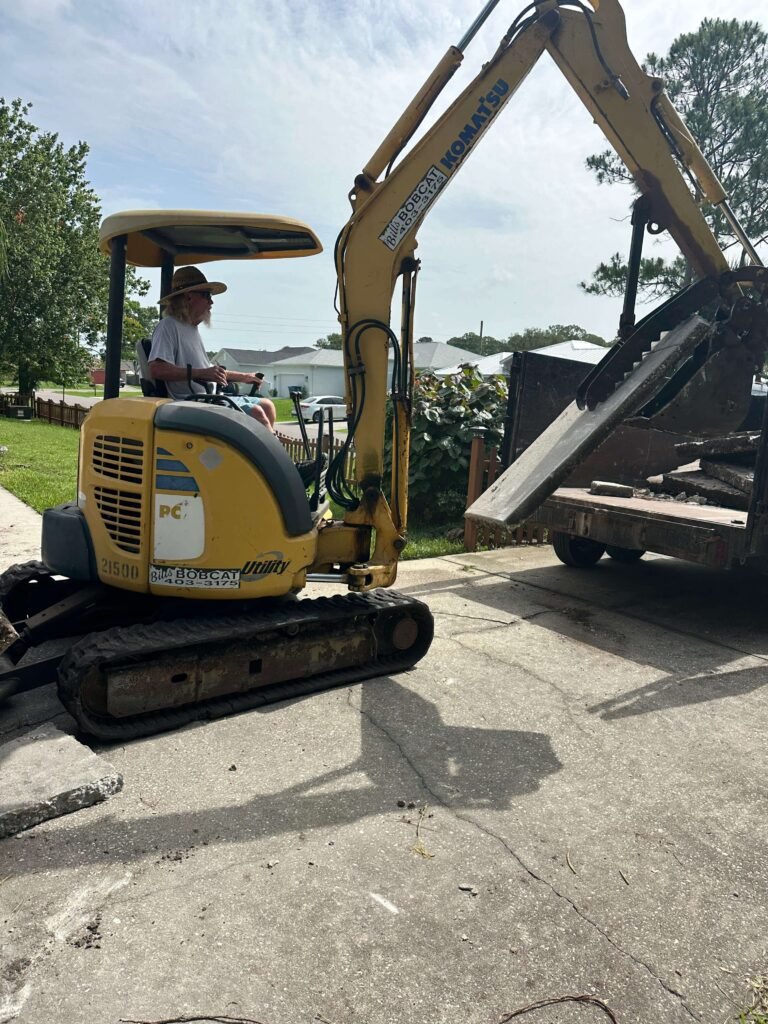 Dumpsters Wiz trailer loaded with concrete driveway debris during driveway demolition Palm Bay FL